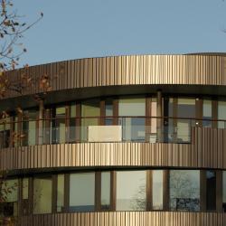 A modern building lit by the setting sun